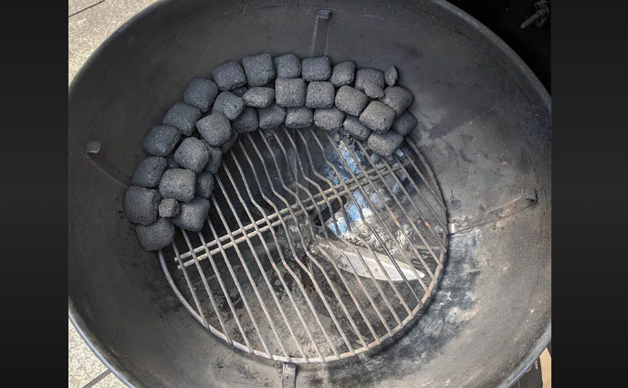 adding charcoal to smoker