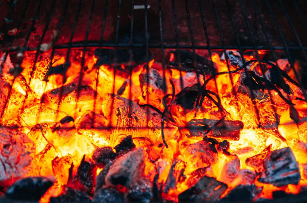 adding charcoal to smoker